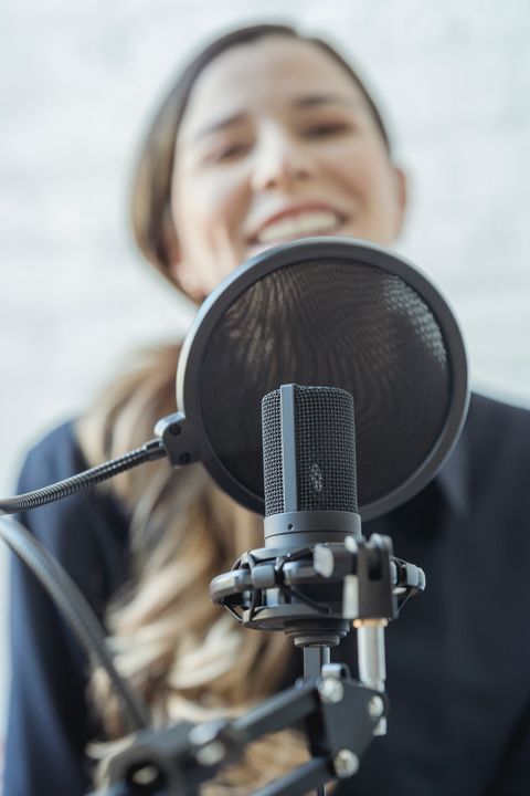 woman-smiling-and-recording-audio